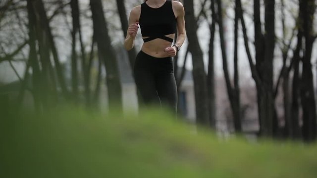 Woman jogging in the spring park