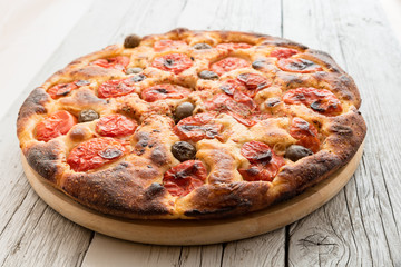 Focaccia typical of Bari Italy with tomatoes and olive