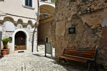 Fototapeta premium Guardia Sanframondi, Italy, 04/30/2018. A narrow street among the small houses of a medieval village in the Campania region