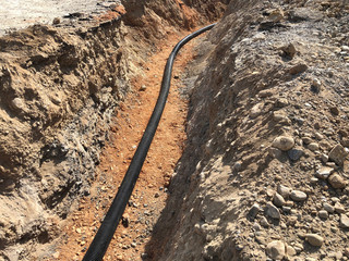 The high voltage electrical cable is laid in a trench