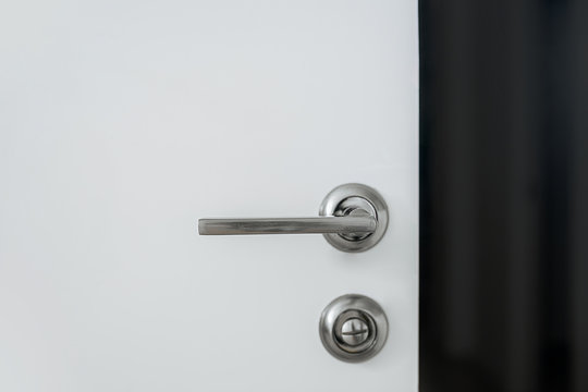 Metal Handle With A Lock On A White Door