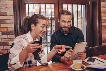 Positive Business people are using digital tablet in cafe
