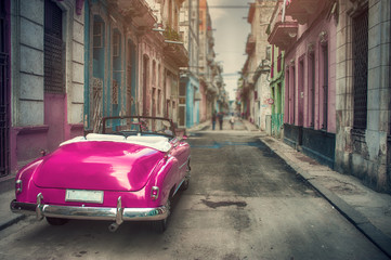 Old red classic car in a street of havana with old building on background - 335488628