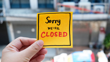 Sorry We' Re' Closed message concept written post it on blur background.