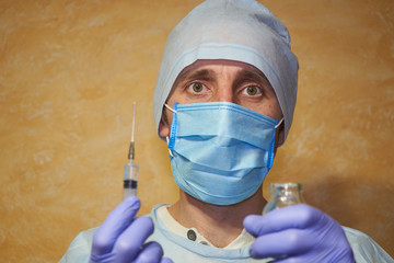 Fototapeta na wymiar doctor in medical mask with antibiotic,tired doctor in medical mask with syringe for flu epidemic, COVID-19