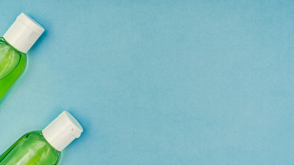 Coronavirus, covid-19. Antiseptic gel, liquid we, protective mask on a blue background. Self-isolation and quarantine, personal protective equipment.