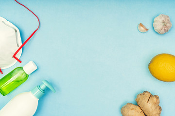 Coronavirus, Covid-19. Lemon and ginger on a blue background. Self-isolation and quarantine, personal protective equipment and healthy nutrition. Natural vitamins during illness.