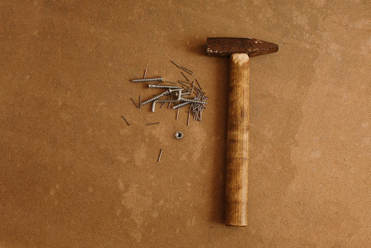 Old hammer and nails on floorboards. concept for tools. Place for text