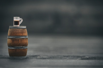 Wooden barrel and beer mug on black wooden background