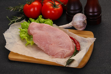 Raw Turkey steak served rosemary