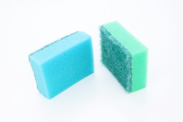 Multi-colored dishwashing sponges are placed on a white background