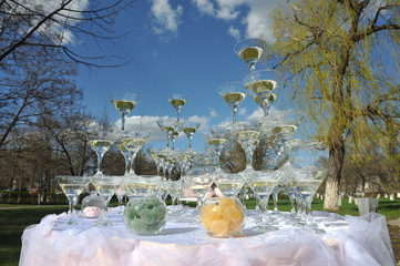 Champagne pyramid at a wedding on the nature. Welcome Drink for guests