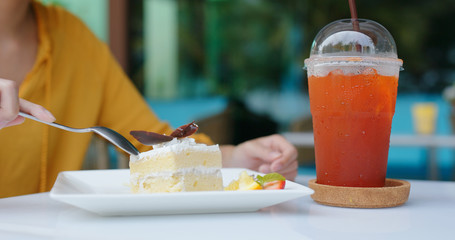 Woman eat cake in coffee shop