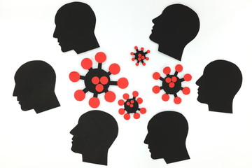 Group of human male profile silhouette and coronavirus cutout in white background. Depression and mental health issue during covid-19 health crisis.