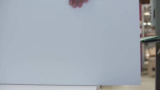Factory worker inspects MDF wood parts Mittel Dichte Fazerplatte