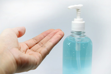 Close up hand with a bottle of alcohol, hand sanitizer generally used to decrease infectious