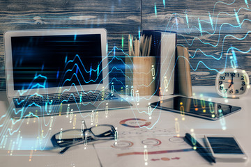 Double exposure of graph and financial info and work space with computer background. Concept of...