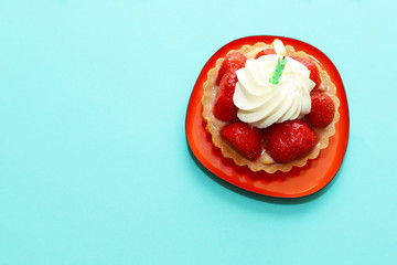 Birthday cake with strawberries and whipped cream.