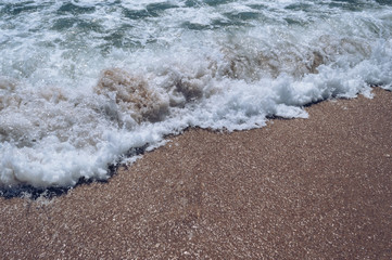 sea foam and sand on sunny day
