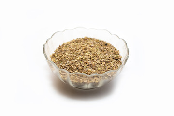 dry coriander in glass pot on white background