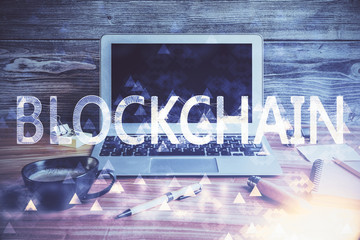 Multi exposure of blockchain and crypto economy theme hologram and table with computer background....