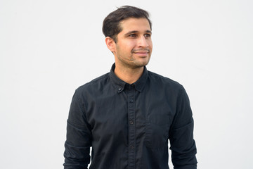 Fototapeta premium Portrait of young handsome Persian businessman thinking