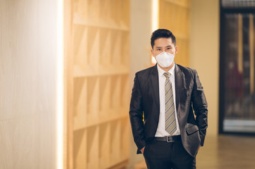 Asian business man standing wear mask protect pollution - corona virus