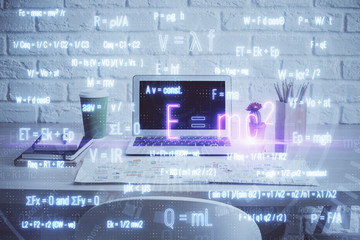 Desktop computer background and formula hologram writing. Double exposure. Education concept.