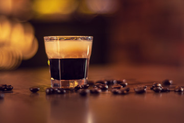 coffee shot on wooden bat table close up