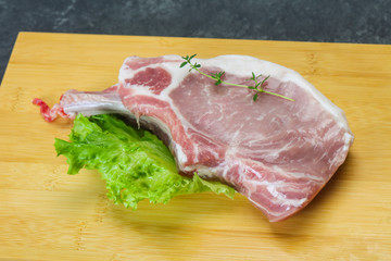 Raw pork bone steak over wooden