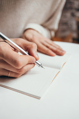 man writing a notes in notebook