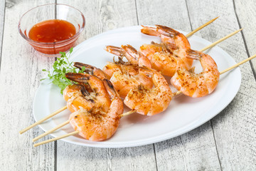 Grilled prawn skewer with sauce