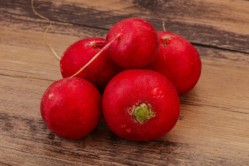 Ripe fresh radish heap over wooden
