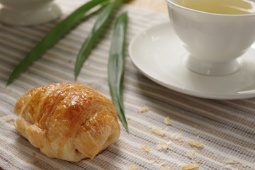 A delicious homemade croissant with earl grey in the afternoon tea.