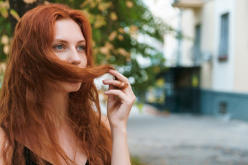 Problem hair concept. Ginger woman with long hairs in hand, copy space