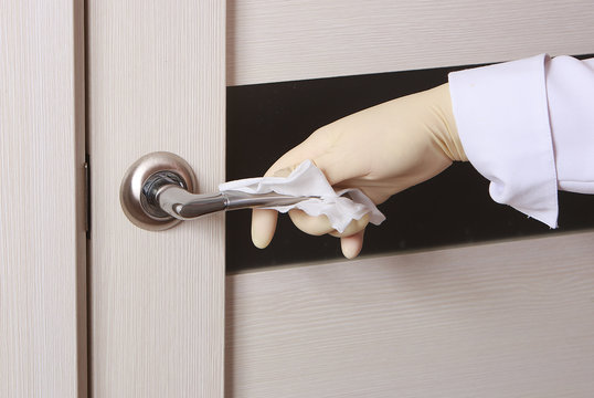 Concept Of Disinfecting Surfaces From Bacteria Or Viruses Sill-life, Hand With Glove Cleaning Door Knob With Disinfectant Wet Wipe Corona Virus, Covid 19