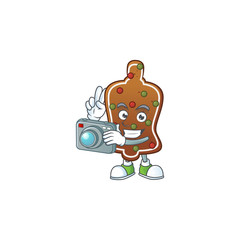 Gingerbread bell photographer mascot design concept using an expensive camera