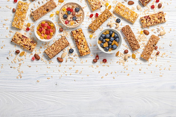 Granola bar with nuts and dry fruit berries. Energy cereal healthy snack. Fitness diet food. Protein muesli bars isolated on white wood. Sport oatmeal bar, top view