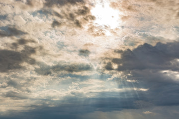 Overcast sky with thick clouds and little sunbeam for background