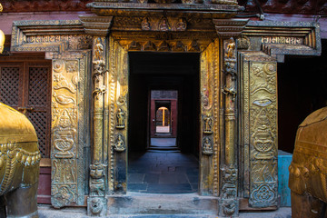 Fototapeta na wymiar The beautiful doorway in golden temple in Patan, unique Buddhist monastery in north of Durbar Square, Kathmandu of Nepal.