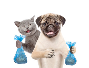 Happy cat and pug dog hold plastic bags. Eco concept. Isolated on white background