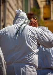 hooded men (battenti) beat their chest with a sponge with a nail, losing blood during septennial...