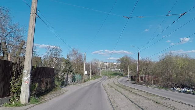 traffic down the old street with bad road tram tracks, debris on the side of the road, no people, no, empty quarantine time and the COVID-19 epidemic