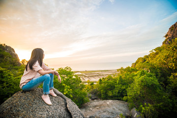 Photographer women enjoying sunrise on mountain