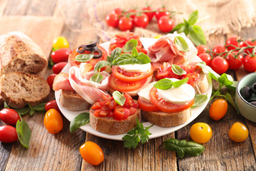 assorted of bruschetta with tomato, ham, mozzarella, olive