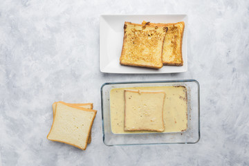 Ingredients and preparation of delicious sweet French toast with cinnamon and vanilla. Quick and easy breakfast, top view