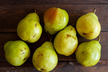fresh ripe green pears on a wooden background