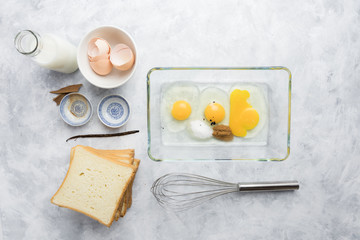 Ingredients and preparation of delicious sweet French toast with cinnamon and vanilla. Quick and easy breakfast, top view