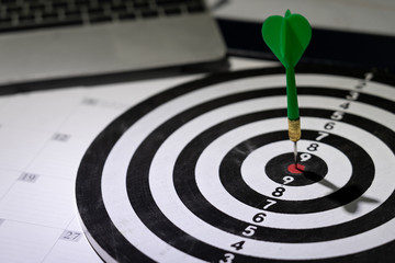 dart hitting target point with laptop computer