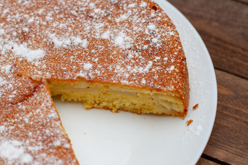 close up of sliced apple pie on a white plate